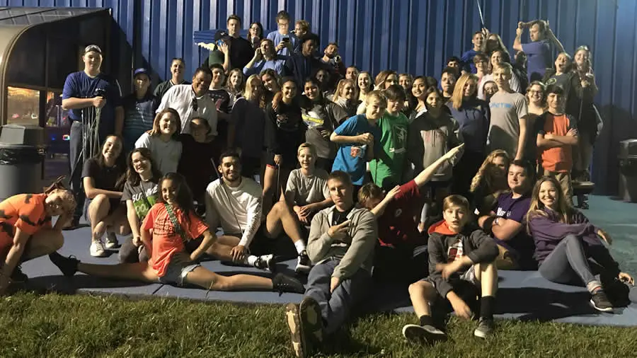 Large group of mostly teenagers posing for a group photo
